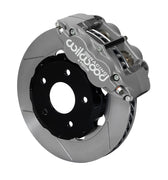 Wilwood front gray Forged Superlite 4R caliper beside a 12.19-inch slotted rotor, angled assembly for Mustang road-race disc spindle