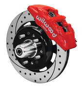 Wilwood front red Dynapro 6 caliper beside a 12.19-inch drilled/slotted rotor, angled assembly for Tri-Five Chevrolet drum spindle