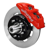 Wilwood front red Dynapro 6 caliper beside a 12.19-inch plain-face rotor, angled assembly for Tri-Five Chevrolet drum spindle