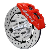 Wilwood front red Dynapro 6 caliper beside a 12.19-inch drilled/slotted rotor, angled assembly for Ford/Mercury six-piston disc conversion