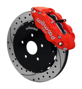 Wilwood front red Superlite 6R caliper beside a 12.88-inch drilled/slotted rotor, angled assembly for Matrix FWD 2.4L front hub