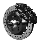 Wilwood front black Superlite 6R caliper beside a 13.06-inch drilled/slotted rotor, angled assembly for CPP truck 13.06-inch brake setup