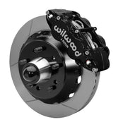 Wilwood front black Superlite 6R caliper beside a 13.06-inch slotted rotor, angled assembly for CPP truck 13.06-inch brake setup