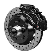 Wilwood front black Superlite 6R caliper beside a 14.00-inch drilled/slotted rotor, angled assembly for CPP truck 14-inch brake setup