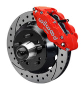 Wilwood front red Superlite 6R caliper beside a 14.00-inch drilled/slotted rotor, angled assembly for CPP truck 14-inch brake setup