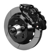 Wilwood front black Superlite 6R caliper beside a 14.00-inch slotted rotor, angled assembly for CPP truck 14-inch brake setup