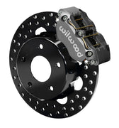 Wilwood front gray Narrow Dynapro caliper beside an 11.75-inch drilled rotor, angled assembly for late F-body thin-rotor drag arrangement