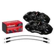 Wilwood black D8-4 front Corvette calipers beside pad packaging, with braided flex lines below