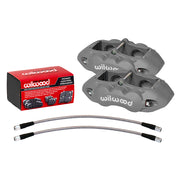 Wilwood gray D8-4 front Corvette calipers beside pad packaging, with braided flex lines below