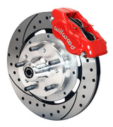 Wilwood front Forged Dynalite Internal kit for GMC/Buick/Chevrolet/Oldsmobile/Pontiac/Isuzu disc spindle: red caliper and 12.19-inch drilled and slotted rotor in assembled view