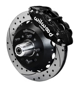 Wilwood front Forged Narrow Superlite 6R kit for Chevrolet drum spindle: black caliper and 12.88-inch drilled and slotted rotor in assembled view