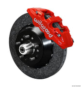 Wilwood ProSpindle carbon-ceramic front single-side assembly with a red AERO6 caliper beside the carbon-ceramic rotor and protruding wheel studs