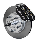 Wilwood GM and Ridetech pin-spindle front single-side assembly showing a black Dynapro dust-boot caliper beside an 11-inch plain-face rotor and protruding wheel studs