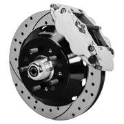 Wilwood TCI IFS front single-side assembly showing a polished Superlite 6R caliper beside a 12.88-inch drilled-and-slotted rotor and protruding wheel studs