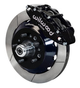 Wilwood TCI IFS front single-side assembly showing a black Superlite 6R caliper beside a 12.88-inch slotted rotor ring and protruding wheel studs