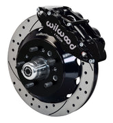 Wilwood TCI IFS front single-side assembly showing a black Superlite 6R caliper beside a 14-inch drilled-and-slotted rotor and protruding wheel studs