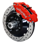 Wilwood TCI IFS front single-side assembly showing a red Superlite 6R caliper beside a 14-inch drilled-and-slotted rotor and protruding wheel studs