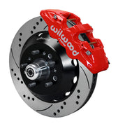 Wilwood TCI IFS front single-side assembly with a red Aero6 caliper beside the drilled-and-slotted rotor and protruding wheel studs