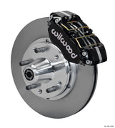 Wilwood Ford and Mercury spindle front single-side assembly showing a black Dynapro dust-boot caliper beside an 11-inch plain-face rotor and protruding wheel studs