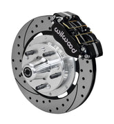 Wilwood Ford and Mercury spindle front single-side assembly showing a black Dynapro dust-boot caliper beside a 12.19-inch drilled-and-slotted rotor and protruding wheel studs