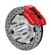 Wilwood Ford and Mercury spindle front single-side assembly showing a red Dynapro dust-boot caliper beside a 12.19-inch drilled-and-slotted rotor and protruding wheel studs