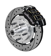 Wilwood ProSpindle front single-side assembly showing a black Dynapro dust-boot caliper beside a 12.19-inch drilled-and-slotted rotor and protruding wheel studs