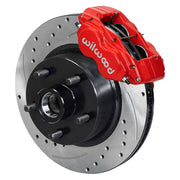 Wilwood later Ford/Mercury front Dynalite-M brake kit assembly example, showing a red caliper positioned over the drilled and slotted rotor/hub