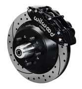 Wilwood full-size front 14-inch Superlite brake kit assembly example, showing a black caliper positioned over the drilled and slotted rotor and mounting hat