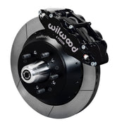 Wilwood full-size front 14-inch Superlite brake kit assembly example, showing a black caliper positioned over the slotted rotor and mounting hat