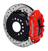 Wilwood staggered Big Ford New Style rear brake kit assembly example, showing a red caliper positioned over the drilled and slotted rotor and mounting hat