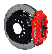 Wilwood staggered GM 12-bolt rear brake kit assembly example, showing a red caliper positioned over the slotted rotor and mounting hat