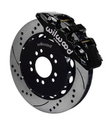 Wilwood Mustang BMR front AERO6 brake kit assembly example, showing a black caliper positioned over the drilled and slotted rotor and mounting hat