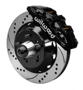 Wilwood Chevy/GMC drop-spindle front AERO6 brake kit assembly example, showing a black caliper positioned over the drilled and slotted rotor and mounting hat