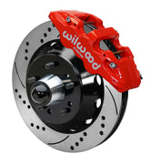 Wilwood Chevy/GMC drop-spindle front AERO6 brake kit assembly example, showing a red caliper positioned over the drilled and slotted rotor and mounting hat