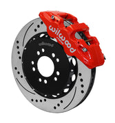 Wilwood Corvette C7 front AERO6 brake kit assembly example, showing a red caliper positioned over the drilled and slotted rotor and mounting hat