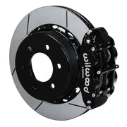 Wilwood six-lug F-150 rear Superlite 6R brake kit assembly example, showing a black caliper positioned over the slotted rotor and mounting hat