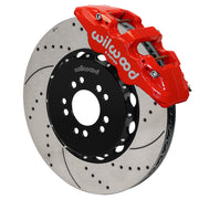 Wilwood red AERO6 front caliper with an assembled 15-inch drilled-and-slotted rotor and black mounting hat, shown for C7 Corvette