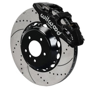 Wilwood black AERO6 front caliper with an assembled 15-inch drilled-and-slotted rotor and black mounting hat, shown for listed BMW 1 and 3 Series applications