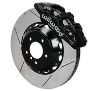 Wilwood black AERO6 front caliper with an assembled 15-inch slotted rotor and black mounting hat, shown for listed BMW 1 and 3 Series applications