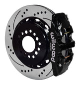 Wilwood black AERO4 caliper over an assembled 14.25-inch drilled-and-slotted rotor and separate mounting hat