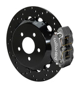 Wilwood gray Dynapro radial rear drag-race caliper with a 12.9-inch drilled steel rotor and black hat, shown for S550 Mustang rear axle