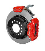 Wilwood red Dynalite service caliper and MC4 parking caliper around a 12.19-inch plain-face rotor, shown for modified GM 12-bolt axles with nonstaggered shocks