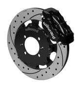 Wilwood black Dynalite caliper over an assembled 12.19-inch drilled-and-slotted rotor and separate mounting hat