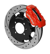 Wilwood red Dynalite caliper over an assembled 12.19-inch drilled-and-slotted rotor and separate mounting hat