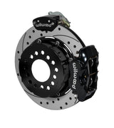 Wilwood black Dynalite service caliper and MC4 parking caliper around a 12.19-inch drilled-and-slotted rotor, shown for modified GM 12-bolt axles with staggered shocks