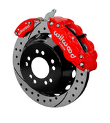 Wilwood red rear Superlite 4R service caliper and separate MC4 parking caliper around a drilled-and-slotted rotor assembly