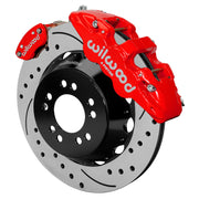 Wilwood red AERO4 service caliper and MC4 parking caliper around a 14-inch drilled-and-slotted rotor, shown for Currie Pro-Tour unit-bearing axles