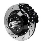 Wilwood black Superlite front caliper over a drilled-and-slotted rotor assembly with a projecting hub and wheel studs