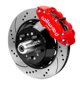 Wilwood red Superlite front caliper over a drilled-and-slotted rotor assembly with a projecting hub and wheel studs