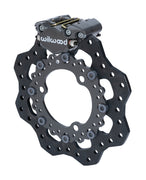 Wilwood Dynapro Single brake kit: Single gray Dynapro caliper mounted beside the scalloped drilled rotor with its round center adapter; no wheel hub; 11.75-inch front brake setup for Dirt Modified.